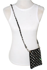 Black studded crossbody bag on a mannequin with a white tank top