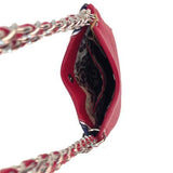 Red handbag with a patterned interior and braided strap on a white background