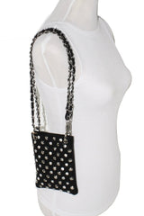 Black studded handbag with chain strap on a white mannequin